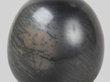an image of a black vase on a white surface