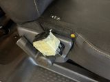 a piece of paper sticking out of the seat of a car