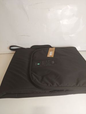une photo montrant une sacoche d'ordinateur portable noire posée sur une table blanche