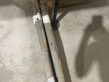 a metal pole that has a piece of wood sticking out of it