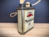 a can of motor oil sitting on a wooden table