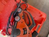 a red tool box with a corded cord and a corded cord