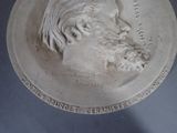 a close up of a plaque of a man with a beard