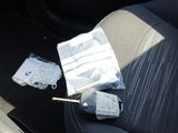a car seat with a remote control and a bag of keys