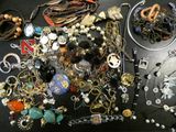 many different types of jewelry on a black table
