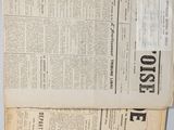 several newspapers are stacked on top of each other on a table
