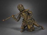 bronze statue of a man holding a stick and a stick