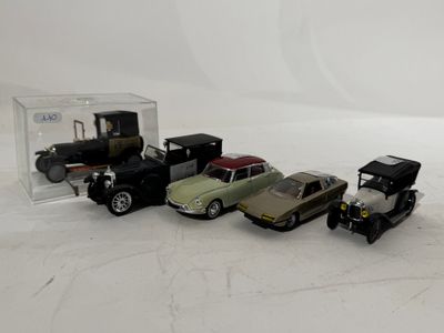several toy cars are lined up in a row on a white surface