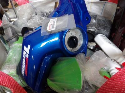a blue blow dryer sitting on top of a pile of other items