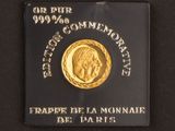 a close up of a gold coin on a black surface