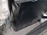 a computer sitting on top of a desk next to a bag
