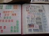 an open book with stamps on it sitting on top of a table