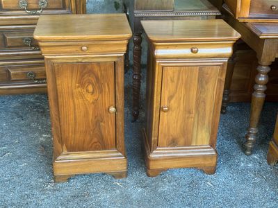 two nightstands that are next to each other on the floor