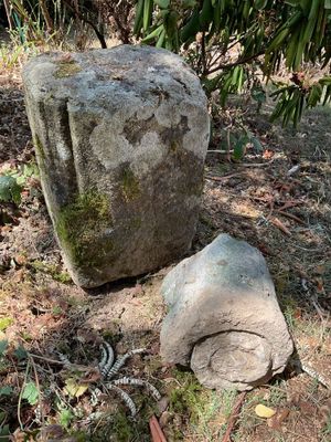 a large rock sitting on the ground next to a large rock