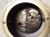 a close up of a clock that is on a table