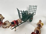 many figurines of people riding in a horse drawn carriage