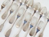 a lot of forks and spoons sitting on a table