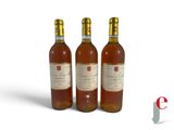 three bottles of wine sitting next to each other on a white surface