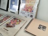 a desk that has a bunch of books and a laptop on it