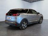 the rear end of a silver car parked in a white room