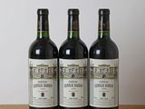 three bottles of wine sitting on top of a wooden table