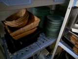 many plates and bowls on the shelves in the kitchen
