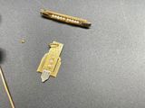 a small piece of jewelry on a table next to a pair of scissors