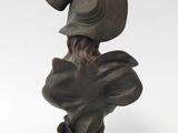 statue of a woman with a hat on her head and a hat on her head
