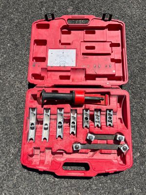 a red case with tools in it sitting on the ground