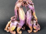 a figurine of two cats on a black background