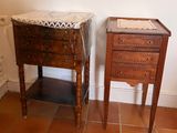 two small wooden tables with drawers on them