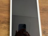 Quelqu'un prend une photo de son téléphone portable posé sur une table en bois.