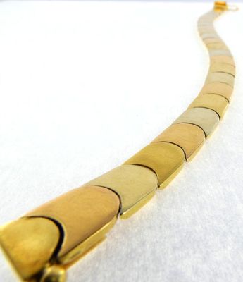yellow gold plated necklace with a curved design on a white background