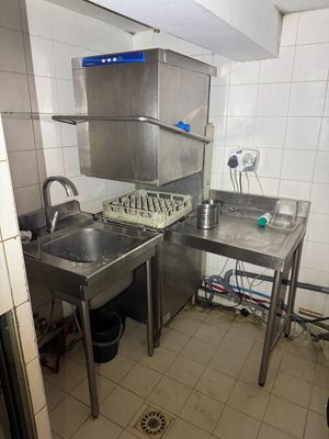 a small kitchen with a sink and a stove in it