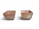 pair of terracotton planters on a white background