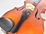 a close up of a violin with a bow on it