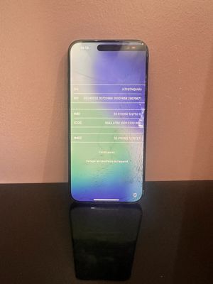 the back of a black phone sitting on top of a black table