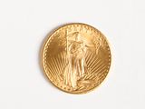a close up of a gold coin on a white surface