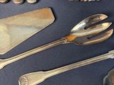 a lot of silver spoons and spoons on a table