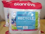 two bags of recycle sitting on a table