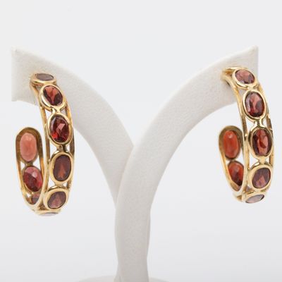 an image of a pair of gold and garnet stone hoop earrings
