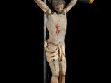 statue of jesus on the cross on a black background