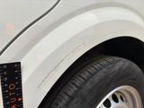 a close up of a white truck with a measuring tape on it