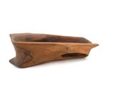 a wooden bowl that is sitting on a white surface