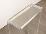 a clear table with a glass top on the floor
