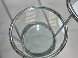 two glasses sitting on a table with a mirror on it