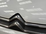 a close up of the front of a car with the hood up