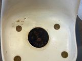 a dirty urinal that is sitting on the floor
