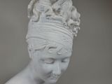 a white statue of a woman with a turban on her head