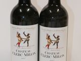 two bottles of red wine sitting next to each other on a table